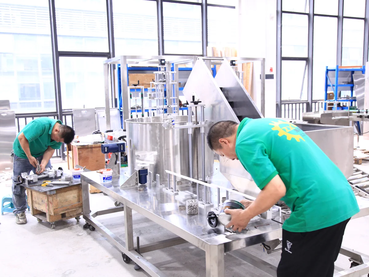 ZXSMART technicians assembling a stainless steel packaging machine