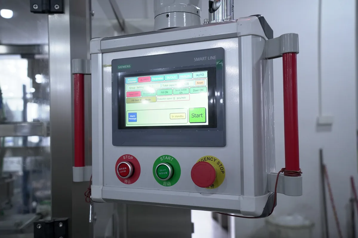 PLC touchscreen control panel on the 8-head flow meter filling machine